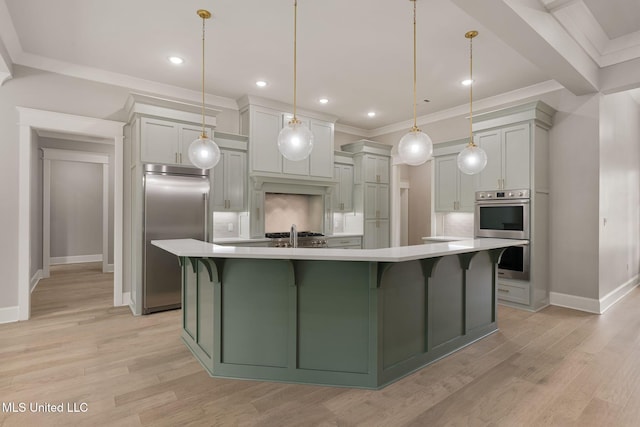 9 Sanctuary Ln, Sumrall, MS 39482 - kitchen featuring appliances with stainless steel finishes, light countertops, a large island, baseboards, and light wood-type flooring