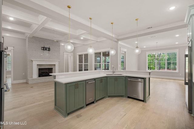 9 Sanctuary Ln, Sumrall, MS 39482 - kitchen with stainless steel dishwasher, a sink, light countertops, open floor plan, and green cabinetry