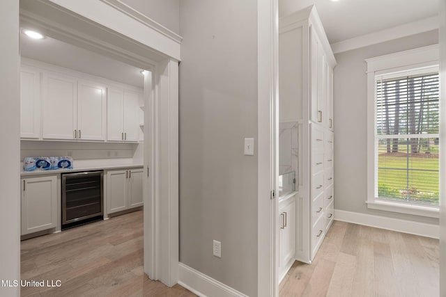 9 Sanctuary Ln, Sumrall, MS 39482 - bar featuring light wood-style floors, a dry bar, baseboards, and wine cooler