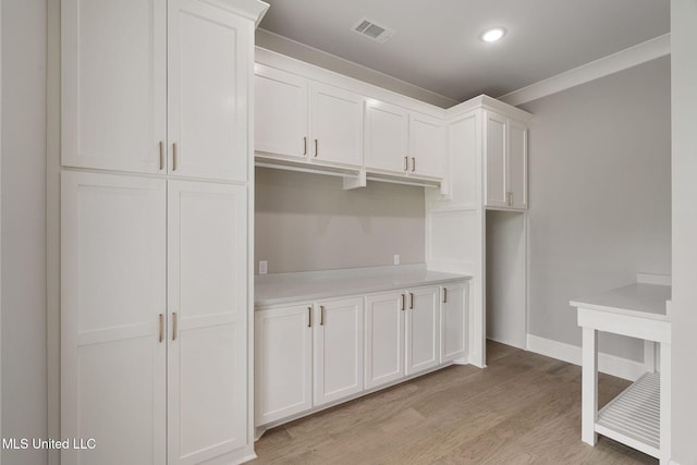 9 Sanctuary Ln, Sumrall, MS 39482 - kitchen with light countertops, white cabinetry, baseboards, light wood-type flooring, and visible vents