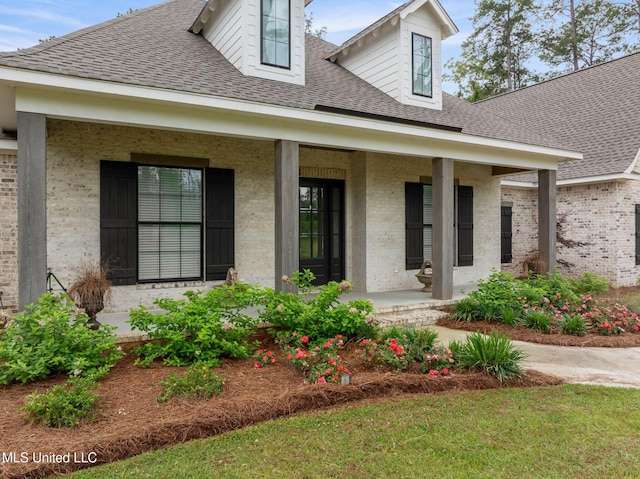 9 Sanctuary Ln, Sumrall, MS 39482 - doorway to property with a shingled roof, a porch, and brick siding