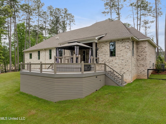 9 Sanctuary Ln, Sumrall, MS 39482 - back of property featuring a lawn, brick siding, a gazebo, and a wooden deck