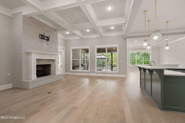 9 Sanctuary Ln, Sumrall, MS 39482 - unfurnished living room with ceiling fan, baseboards, light wood-type flooring, beamed ceiling, and coffered ceiling