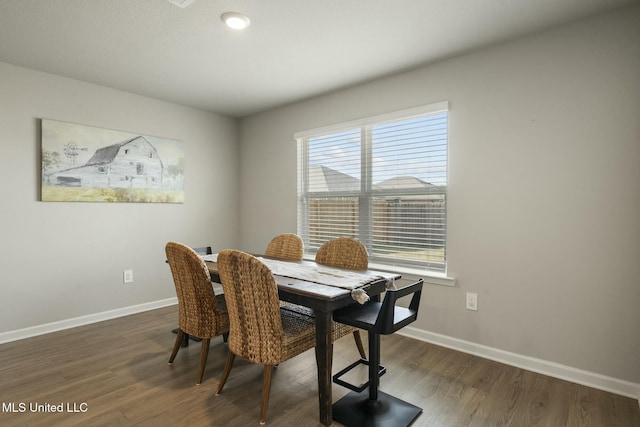 dining space featuring dark hardwood / wood-style flooring and a wealth of natural light