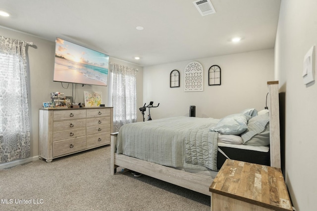 bedroom featuring multiple windows and light colored carpet