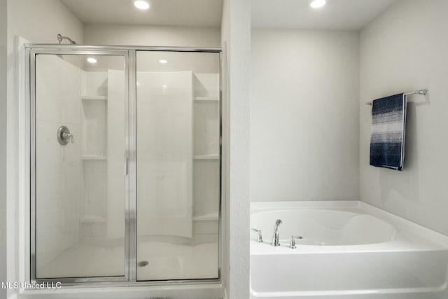 bathroom with shower with separate bathtub