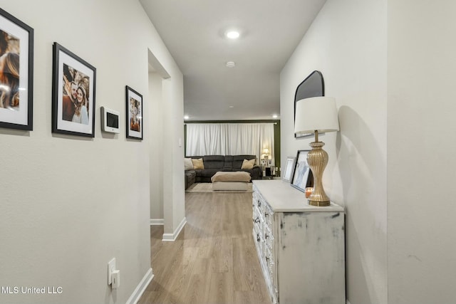 hallway with light hardwood / wood-style flooring