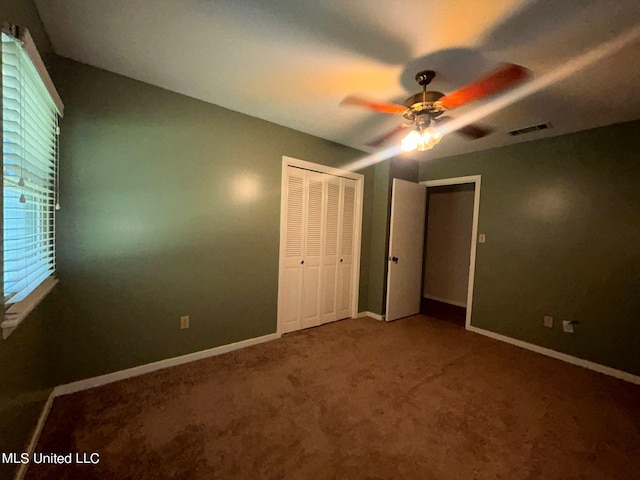 unfurnished bedroom featuring a closet, carpet floors, and ceiling fan