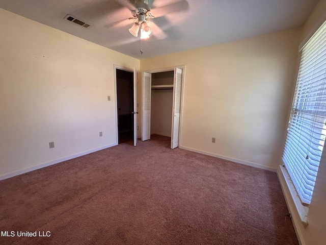 unfurnished bedroom with a closet, carpet flooring, and ceiling fan