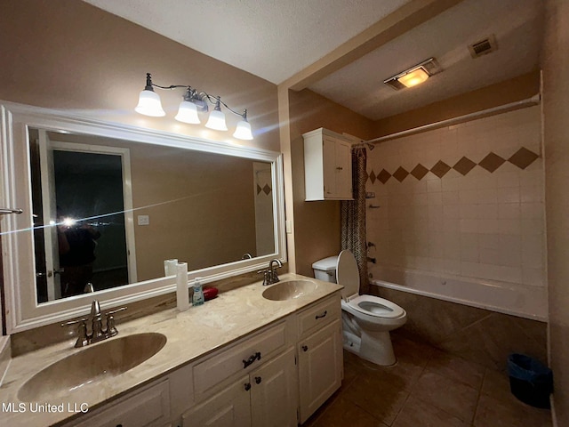 full bathroom with vanity, shower / bath combo, toilet, and tile patterned floors