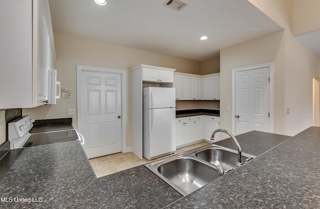 kitchen featuring sink, white appliances, and white cabinets