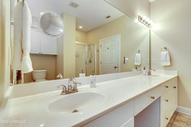 bathroom with an enclosed shower, vanity, and toilet