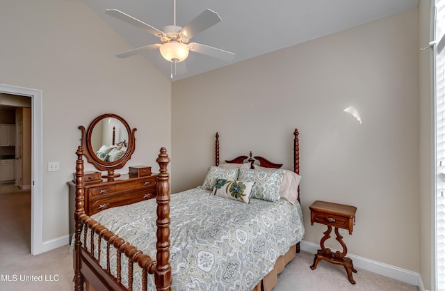 bedroom with vaulted ceiling, light colored carpet, and ceiling fan