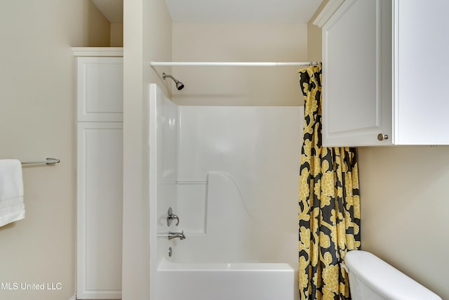 bathroom featuring shower / bath combination with curtain and toilet