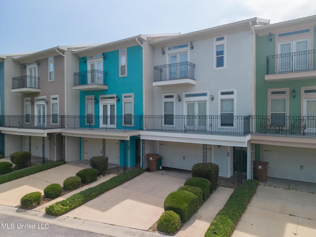 25 Oak Alley Ln Unit 25, Long Beach, MS 39560 - view of front of house featuring a garage, stucco siding, and driveway