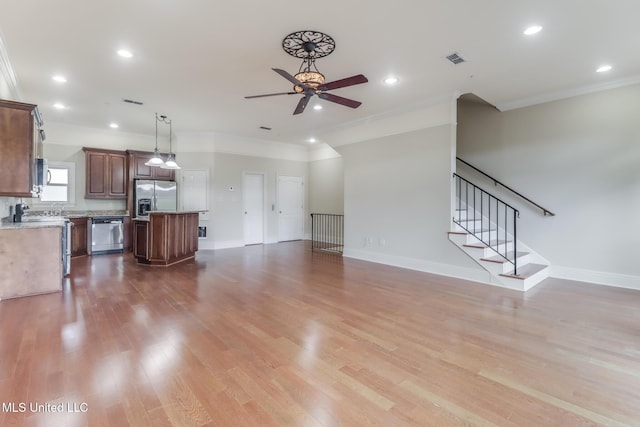 25 Oak Alley Ln Unit 25, Long Beach, MS 39560 - unfurnished living room featuring crown molding, a ceiling fan, light wood-type flooring, stairs, and recessed lighting