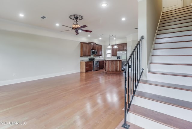25 Oak Alley Ln Unit 25, Long Beach, MS 39560 - unfurnished living room featuring a ceiling fan, stairs, light wood-style floors, recessed lighting, and crown molding