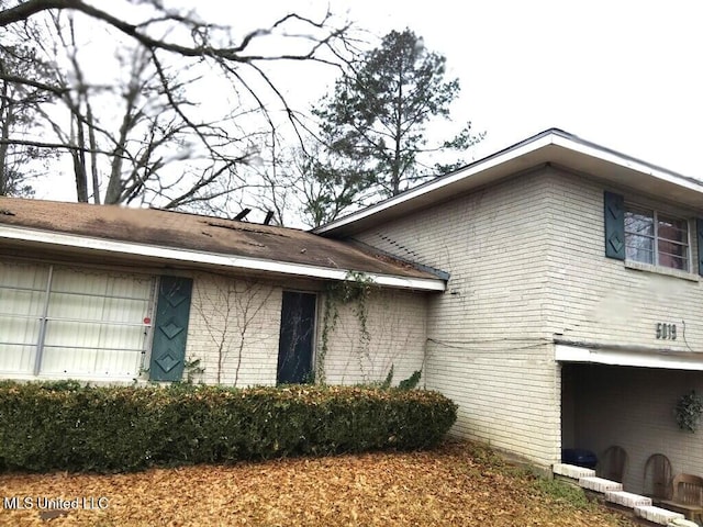 exterior space with brick siding