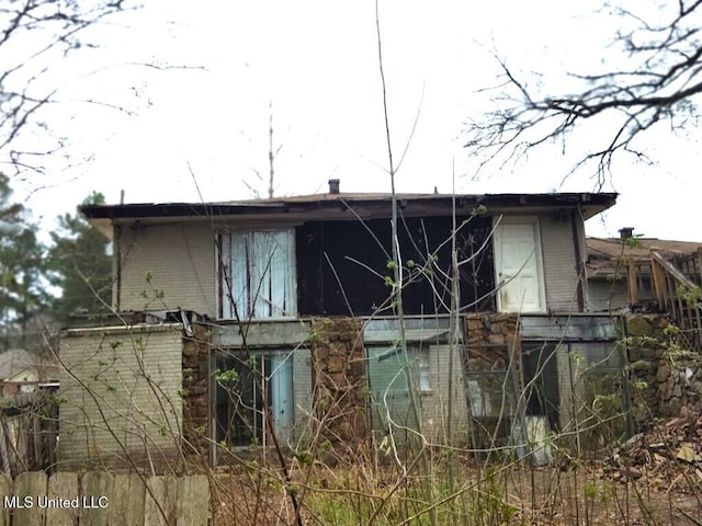 view of side of property with brick siding