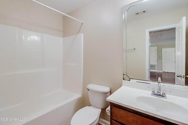 full bathroom with toilet, vanity, and washtub / shower combination