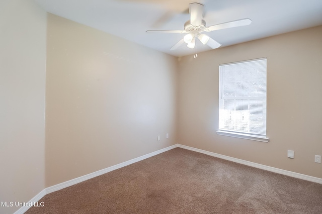 carpeted spare room featuring ceiling fan