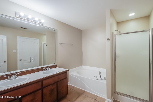 bathroom featuring tile patterned flooring, shower with separate bathtub, and vanity