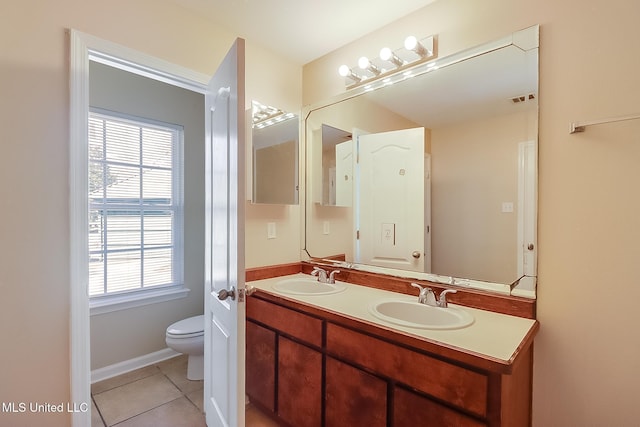 bathroom featuring tile patterned floors, toilet, and vanity