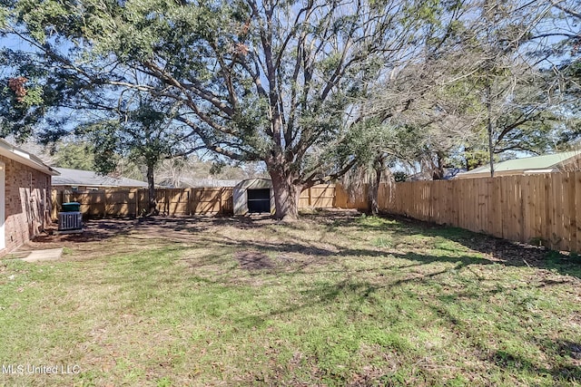 view of yard with central AC and a storage shed