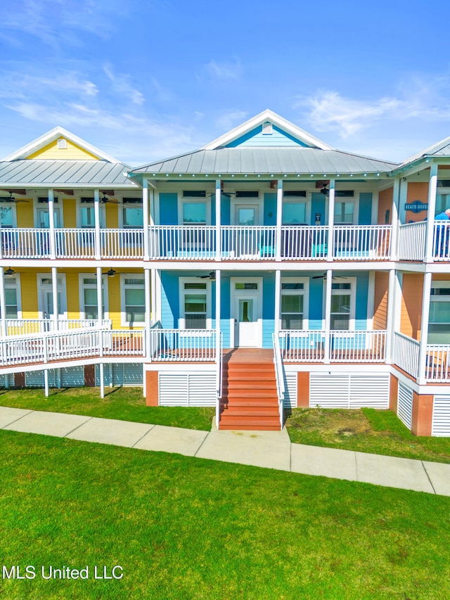 1515 E Beach Blvd Unit 114, Pass Christian, MS 39571 - view of front of home with a standing seam roof, ceiling fan, a front lawn, and metal roof