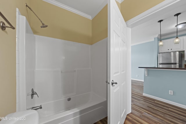 1515 E Beach Blvd Unit 114, Pass Christian, MS 39571 - bathroom featuring crown molding, shower / washtub combination, wood finished floors, baseboards, and toilet