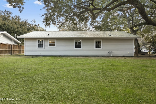 rear view of house with a lawn