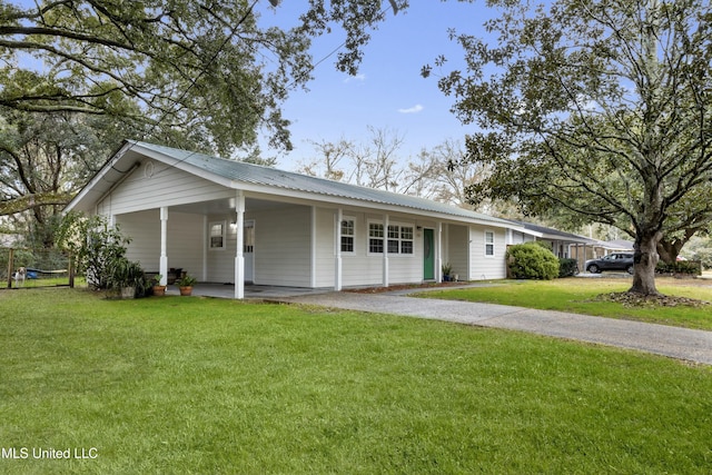 single story home featuring a front lawn and a carport