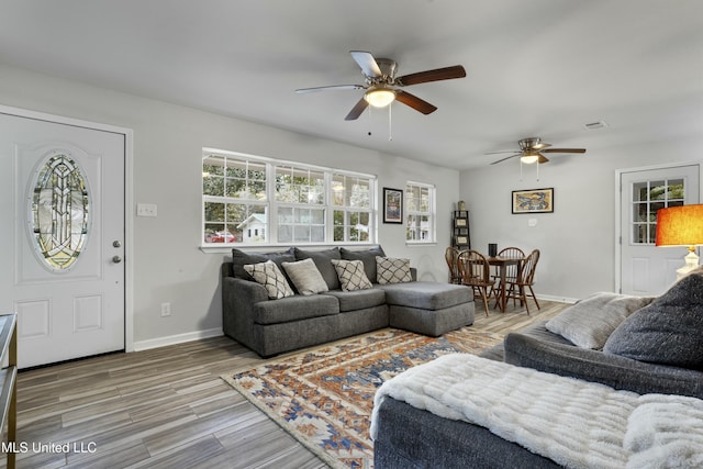 living room with hardwood / wood-style flooring and ceiling fan