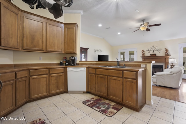 311 Pinecrest Blvd, Long Beach, MS 39560 - kitchen with white dishwasher, a sink, a peninsula, open floor plan, and light tile patterned floors