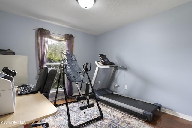 311 Pinecrest Blvd, Long Beach, MS 39560 - workout room featuring baseboards and wood finished floors
