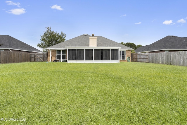 311 Pinecrest Blvd, Long Beach, MS 39560 - rear view of house featuring a sunroom, a chimney, brick siding, and a shingled roof