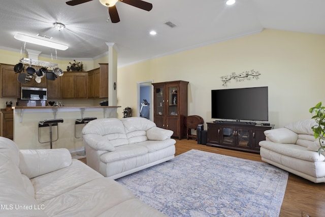 311 Pinecrest Blvd, Long Beach, MS 39560 - living room featuring a ceiling fan, wood finished floors, ornamental molding, and vaulted ceiling