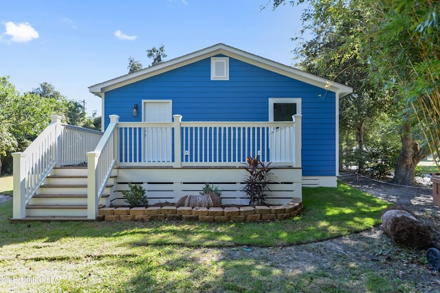 back of house with a yard and a wooden deck