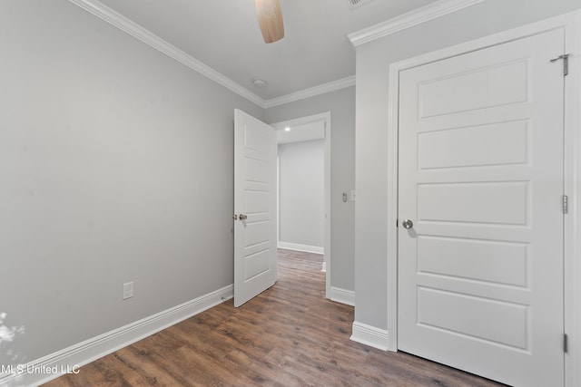 unfurnished bedroom featuring ceiling fan, dark hardwood / wood-style flooring, and ornamental molding