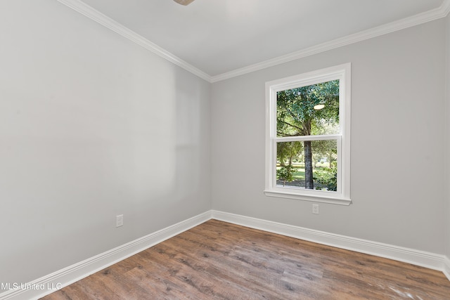 spare room featuring hardwood / wood-style floors and crown molding