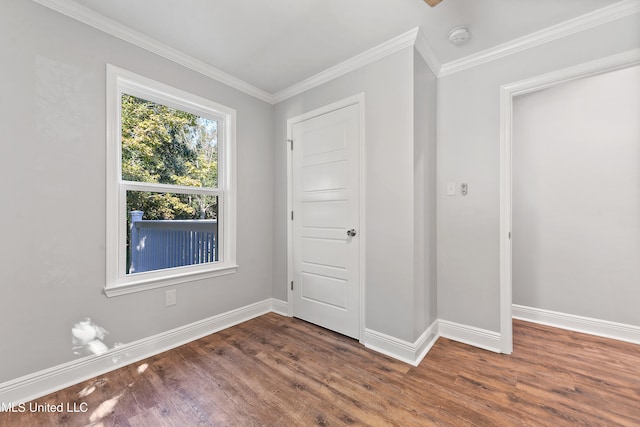 unfurnished bedroom with crown molding and dark hardwood / wood-style floors