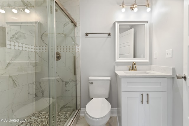 bathroom with vanity, toilet, and a shower with shower door