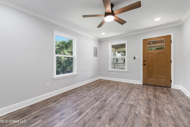 interior space featuring hardwood / wood-style flooring, ceiling fan, crown molding, and electric panel