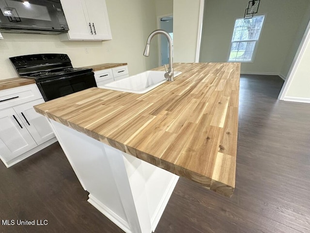 kitchen with butcher block counters, sink, black appliances, white cabinets, and dark wood-type flooring