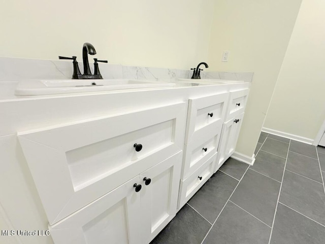 104 Patricia Cv, Raymond, MS 39154 - bathroom featuring tile patterned flooring, double vanity, and baseboards