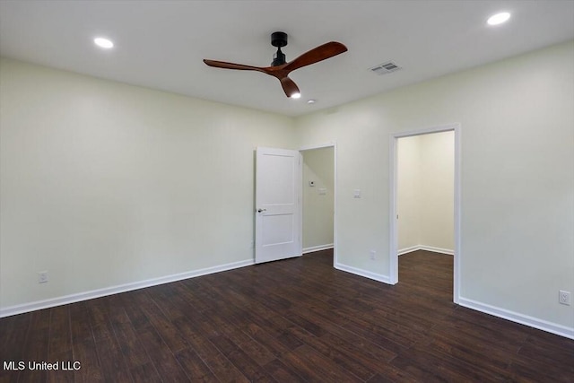 empty room featuring dark hardwood / wood-style flooring and ceiling fan