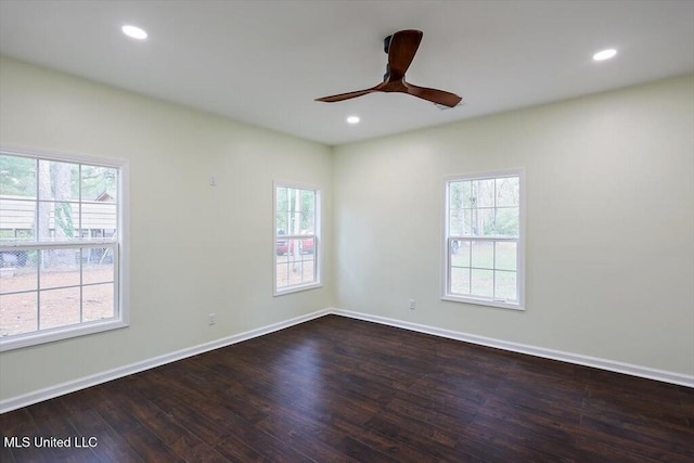 spare room featuring a wealth of natural light, wood-type flooring, and ceiling fan