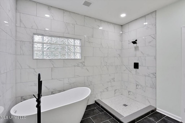 bathroom with tile walls, tile patterned flooring, and separate shower and tub