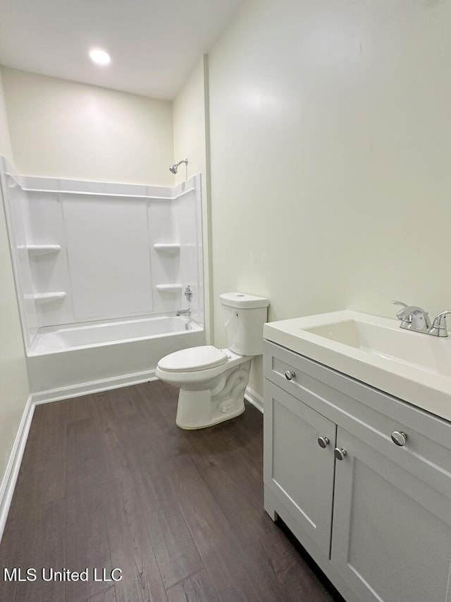 104 Patricia Cv, Raymond, MS 39154 - bathroom with toilet, vanity, wood finished floors, washtub / shower combination, and baseboards