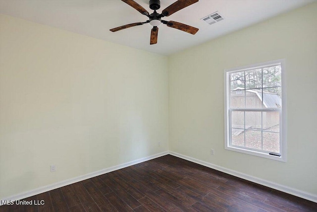 spare room featuring dark hardwood / wood-style flooring and ceiling fan